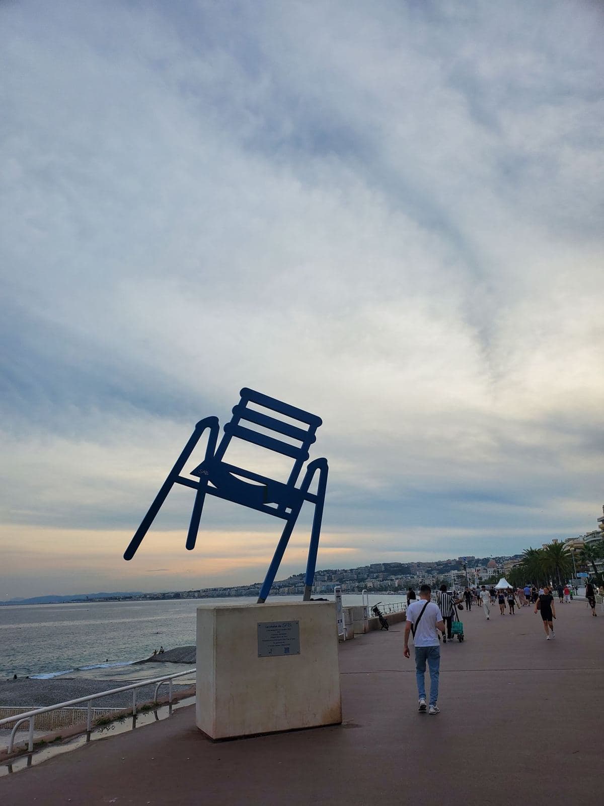 The blue chair sculpture on the Promenade des Anglais at dusk